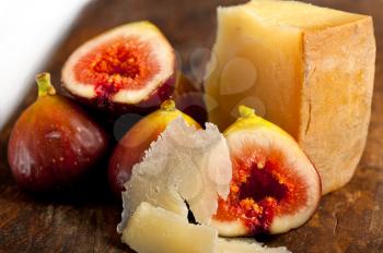 italian pecorino cheese and fresh figs macro closeup over old wood boards