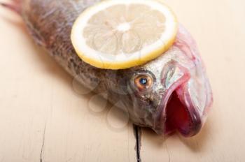 fresh whole raw fish on a wooden table ready to cook