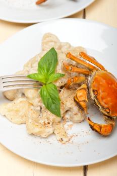 fresh homemade Italian gnocchi with seafood sauce crab and basil