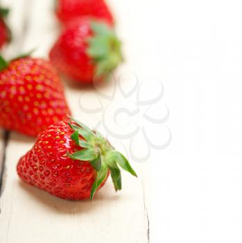 fresh organic strawberry over white rustic wood table
