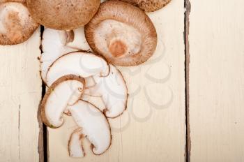 fresh shiitake mushrooms on a rustic wood table 
