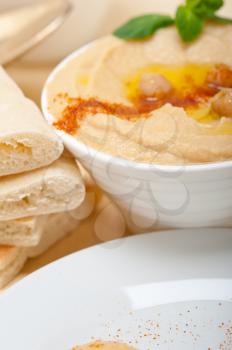 traditional chickpeas Hummus with pita bread and paprika on top 