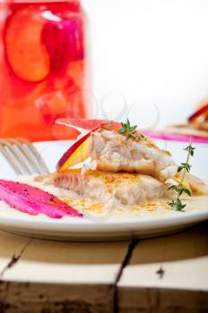 sea bream orata  fillet butter pan fried with fresh peach prune and dragonfruit slices thyme on top