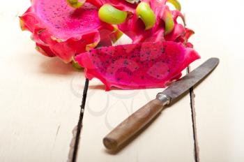 fresh thai purple dragon fruit over white rustic table