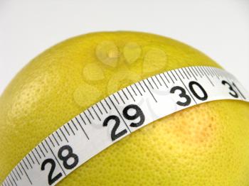 Royalty Free Photo of a Grapefruit With Measuring Tape