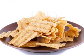 Wheat chips on plate isolated on white background.