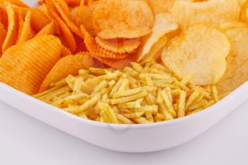 Potato chips in bowl, closeup image.