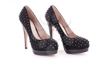 Black spiked shoes isolated on white background.