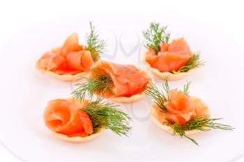 Salmon rolled fillet in pastries on plate.