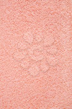 Peach color towel texture as a background, closeup picture.