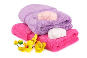 Towels, soaps and flowers isolated on white background.