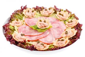 Fish cream and  capers in pastries, ham and lettuce on plate.