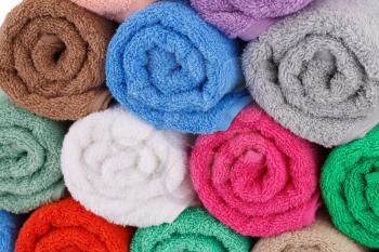 Colorful rolled towels stack closeup picture.