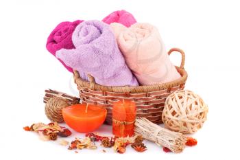 Spa set with towels, candles and dried flower isolated on white background.
