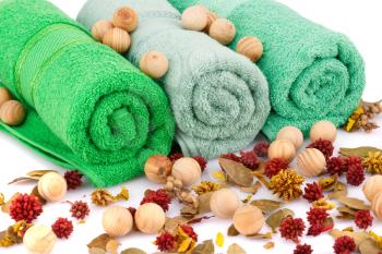 Spa set with towels, wooden balls and dried flowers closeup picture.