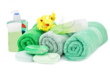 Spa set with towels, cream, lotion, soaps and orchid flowers isolated on white background.