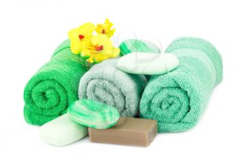 Spa set with towels, soaps and orchid flowers isolated on white background.