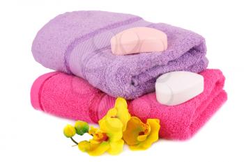 Towels, soaps and flowers isolated on white background.