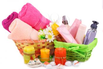 Spa set with towels, creams, lotions, candles, stones and flower isolated on white background.