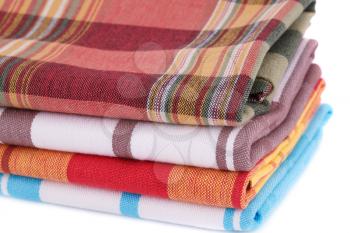 Stack of colorful kitchen towels on white background.