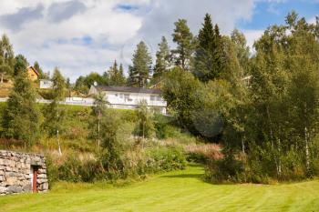 Beautiful rural scene with village, lake amd mountains in Norway.