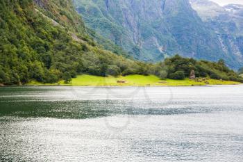 Landscape with Naeroyfjord, mountains and traditional village house in Norway.