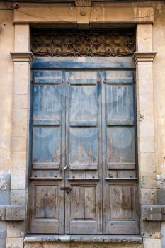 Old wooden door with metallic ornament in Limassol, Cyprus.