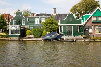 Traditional, authentic dutch houses and boat at the canal.