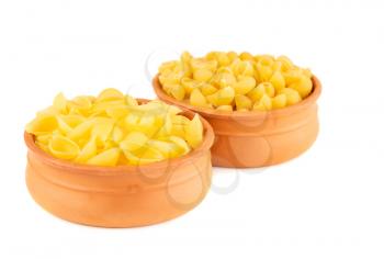 Various kind of Italian pasta in the clay bowls isolated on white background..