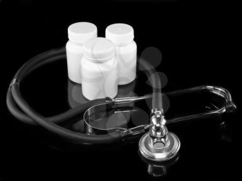 Stethoscope with medicine blank bottles on black background.