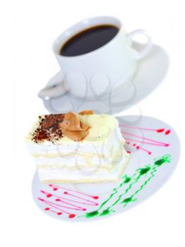 Sponge cake and on original decorating plate with cup of coffee. Isolated