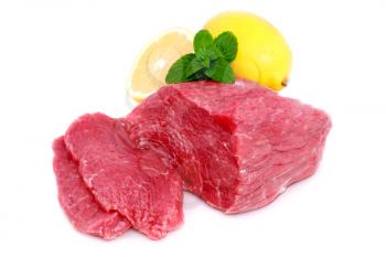 Cut of  beef steak  with lemon slice. Isolated.