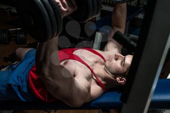 young bodybuilder doing bench press for chest