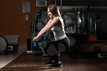 Young Woman Working Out With Kettle Bell