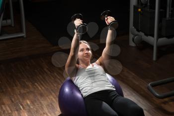 Young Woman Doing Heavy Weight Exercise For Chest