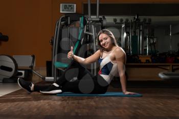 Young Woman Stretches In Fitness Club