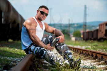 Bodybuilder Resting And Drinking Protein Shake