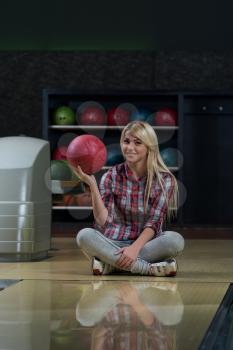 Happy Bowler Sitting At The Bowling Alley