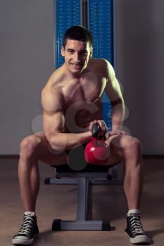 Young Man Exercise With Kettle Bell Biceps