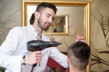 Handsome Man At The Hairdresser Blow Drying His Hair