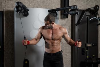 Young Man Is Working On His Chest With Cable Crossover In A Modern Fitness Center