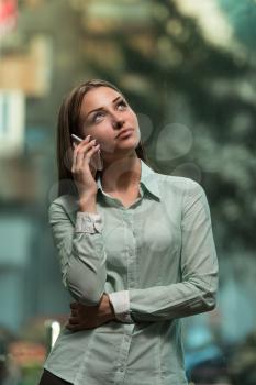 Successful Businesswoman Or Entrepreneur Talking On Cellphone While Working Indoors - City Business Woman Working