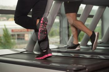 Close Up Of Couples Legs Running On Treadmill - Blurred Motion