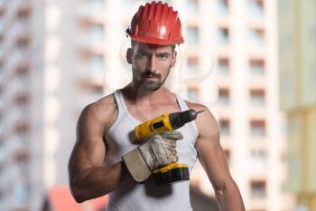 Successful Male Architect At A Building Site With Drill
