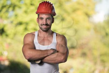 Portrait Of Handsome Male Architect Engineer With Red Helmet