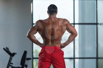 Portrait Of A Young Physically Fit Hispanic Man Showing His Well Trained Abdominal Muscles - Muscular Athletic Bodybuilder Fitness Model Posing After Exercises