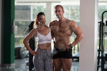 Portrait Of A Sexy Couple In The Gym With Exercise Equipment