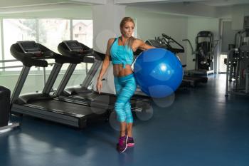 Mature Fitness Woman Working Out In Gym Fitness Center On Ball