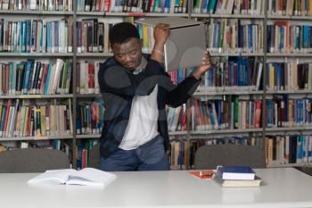African Male Student Throwing Laptop And Want To Destroy It - Shallow Depth Of Field