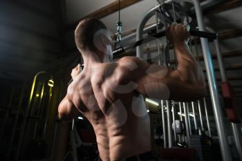 Bodybuilder Doing Heavy Weight Exercise For Back On Machine